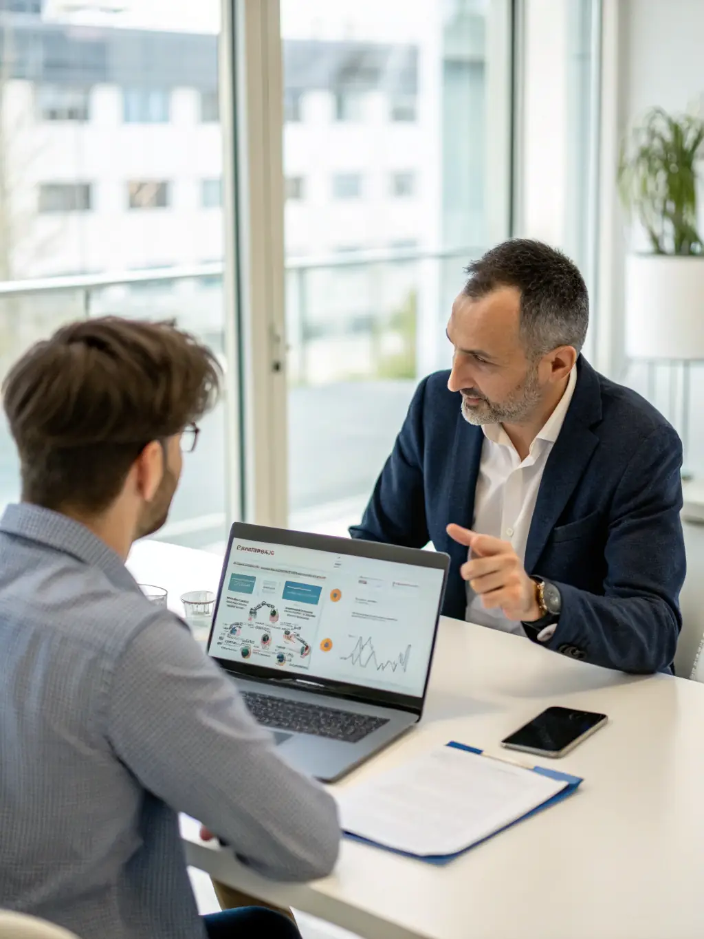 A consultant discussing IT strategies with a client in a modern office setting, representing catchfuture's IT Consulting service.